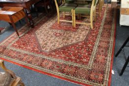 A large machine-made Indian carpet on red ground,