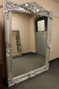 A large silvered framed over mantel mirror
