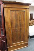 An early 20th century single door wardrobe