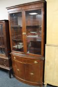 A mahogany glazed door bookcase with cupboard beneath