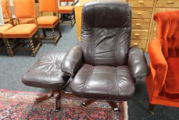 A Stouby brown leather revolving armchair and stool
