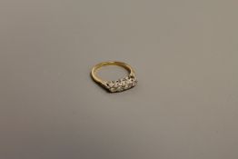 An 18ct gold four stone diamond ring