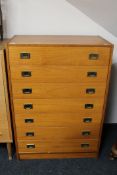 A late twentieth century seven drawer chest with brass drop handles