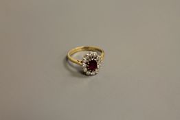 An 18ct gold ruby and diamond cluster ring, size N-O, 4.1g.