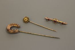 A gold horseshoe brooch, a diamond set pin and a seed pearl and garnet brooch, 6.