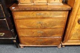 A late nineteenth century mahogany four drawer chest on bun feet
