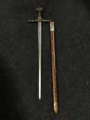 A longsword in scabbard with brass handle and pommel