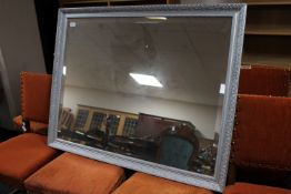 A silvered framed mirror