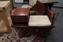 A hardwood telephone seat