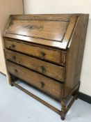 An oak bureau on twist legs