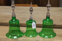 A set of three green glass cloches,
