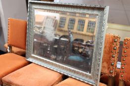 A silvered framed mirror