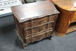 A twentieth century carved oak three drawer chest