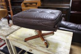 A mid 20th century brown leather footstool on rosewood base