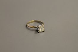 A 14ct gold solitaire diamond ring, the princess-cut stone weighing 1.