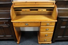 A contemporary pine roll top desk