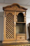 An antique pine wall cabinet