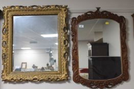 A carved oak framed wall mirror together with a decorative gilt framed mirror