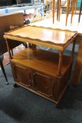 A mahogany serving trolley with lift off gallery tray with cupboard beneath