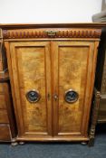 A late nineteenth century double door cabinet with walnut panel doors