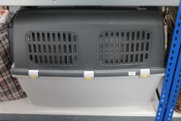 A large plastic pet carrier