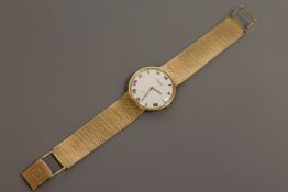 A Gents 9ct gold Tissot wristwatch, on 9ct gold integral bracelet, 50.