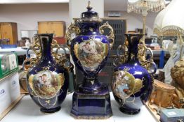 An early twentieth century blue and gilt transfer printed vase trio