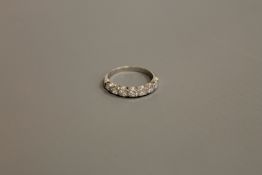 An 18ct white gold seven stone diamond half eternity ring, 2.7g, size M.
