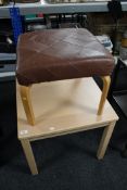 A contemporary beech effect coffee table together with a leather upholstered stool