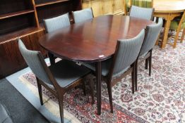 A late 20th century mahogany extending table with two leaves and six chairs