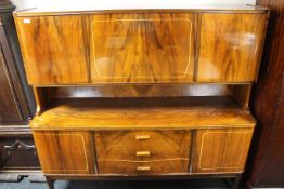 A mid 20th century walnut cocktail sideboard