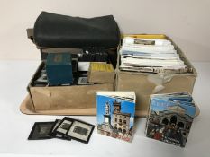 A tray of 20th century postcards, glass negatives,