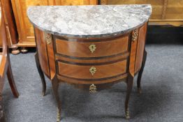 An inlaid mahogany demi-lune two drawer chest with ormolu mounts and marble top (a/f)