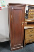 An oak gun cabinet with keys