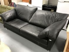 A contemporary black leather settee
