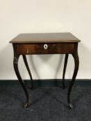 An antique mahogany sewing table