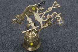 A brass bell with wall bracket