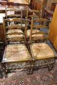A set of four oak rush seated ladder backed dining chairs