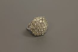 An impressive diamond cluster ring, set with 37 brilliant cut stones,