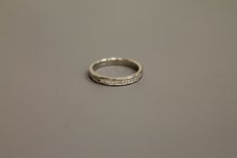 A platinum princess cut diamond half eternity ring, approximately 0.7ct, size M.