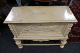 An early 20th century painted carved oak cabinet