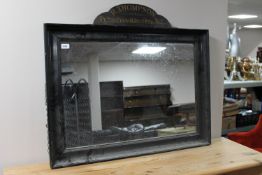 A painted framed mirror with a R.