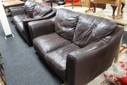 A brown leather three seater settee and matching two seater settee