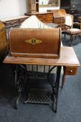 A Singer treadle sewing machine in oak table