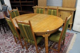 An eight piece blonde oak dining room suite