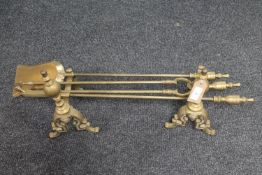 A pair of brass fire dogs and a companion set CONDITION REPORT: Generally in very