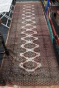 A fringed Afghan woollen runner,