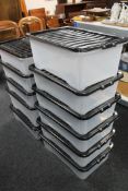 Eleven plastic storage crates with lids