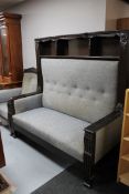 An early 20th century oak framed settee with matching armchair