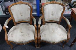 A pair of carved walnut armchairs